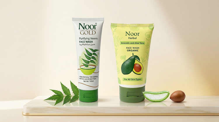 Noor Gold Purifying Neem face wash and Noor Herbal avocado and aloe vera organic face wash displayed with neem leaves and aloe on a marble surface.