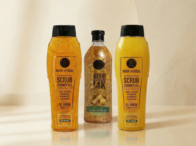 Noor Herbal exfoliating scrub shower gel and 24K gold body scrub displayed in clear bottles on a soft neutral background.