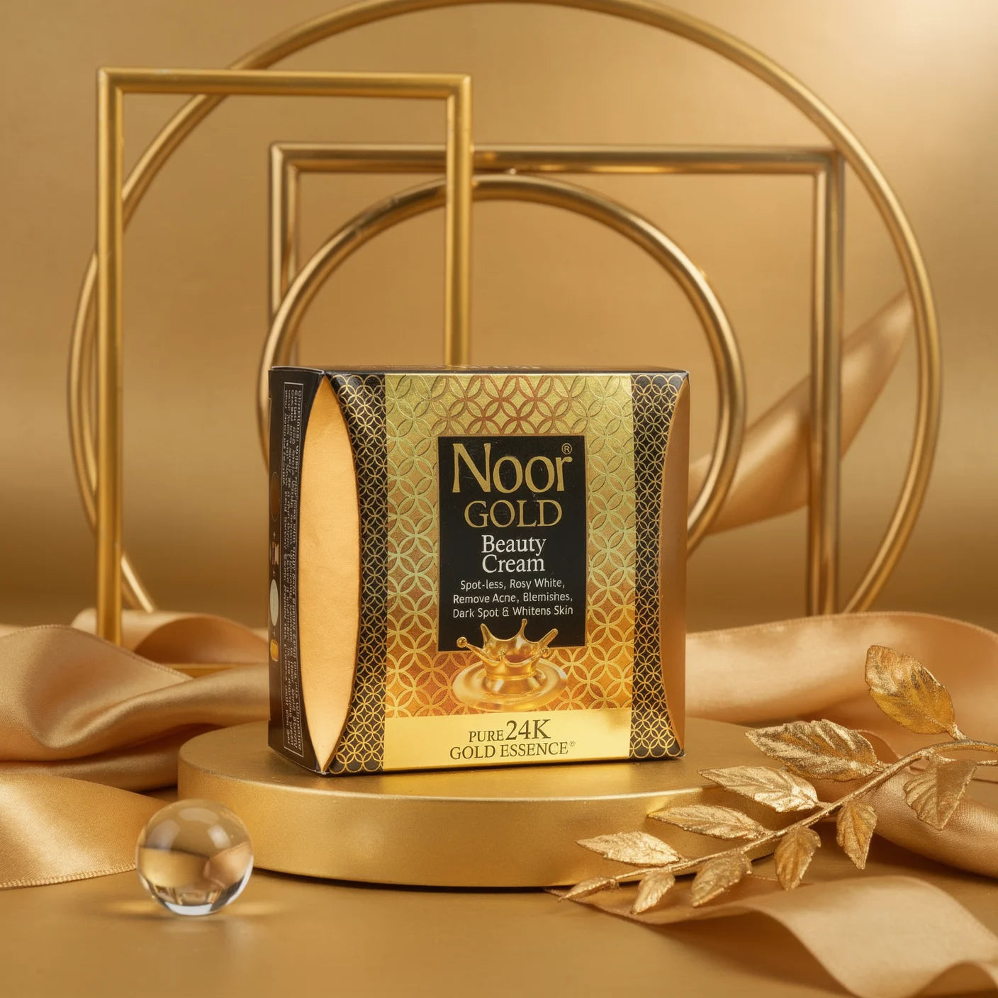 Noor Gold Beauty Cream packaging on a gold background with decorative elements